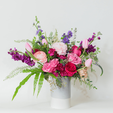 This vibrant and romantic flower arrangement bursts with rich, bold colors and soft, complementary hues, creating a lively and dynamic display.