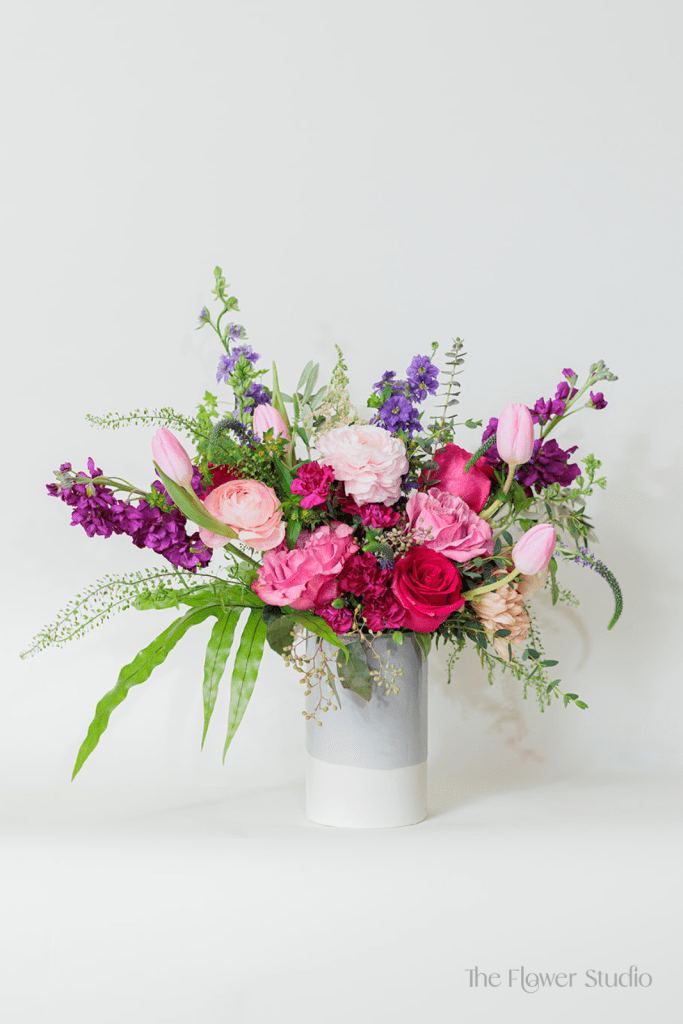 This vibrant and romantic flower arrangement bursts with rich, bold colors and soft, complementary hues, creating a lively and dynamic display.