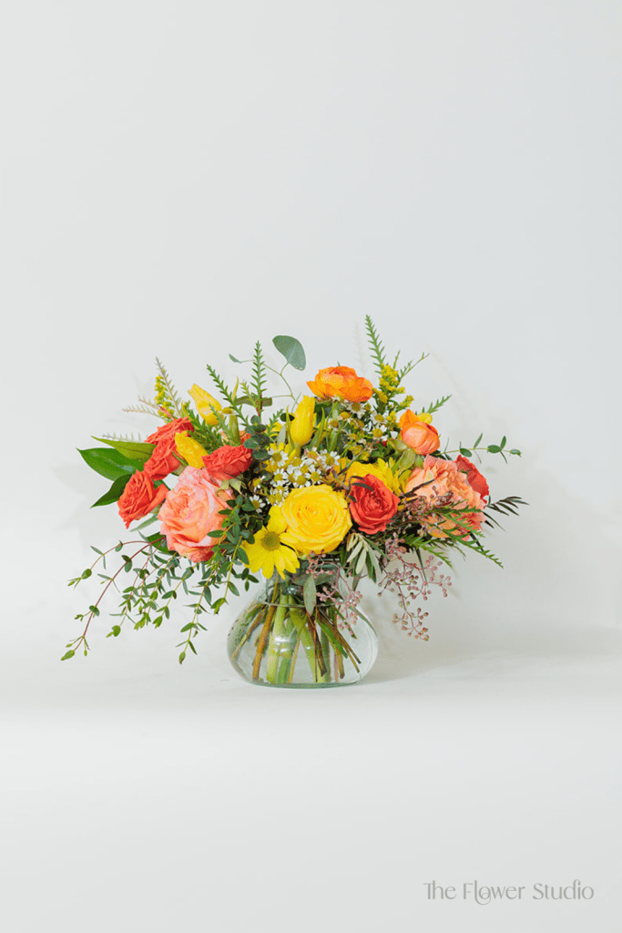 Vibrant, sunny, and full of warmth, this stunning arrangement bursts with rich oranges and cheerful yellows!