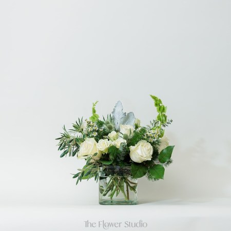 Soft, sophisticated, and full of charm, this stunning floral arrangement combines delicate whites with vibrant greens for a look that’s both refreshing and elegant.