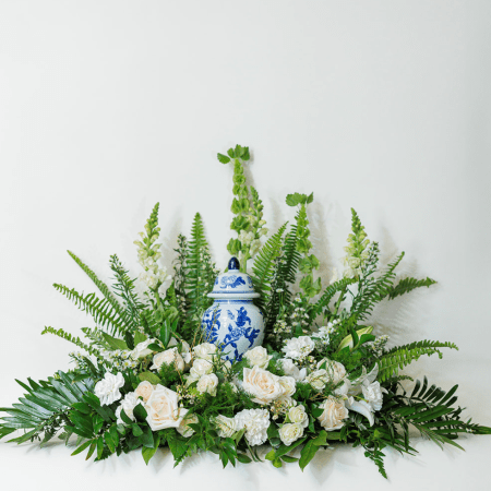 This elegant sympathy arrangement is designed to convey peace, grace, and remembrance.