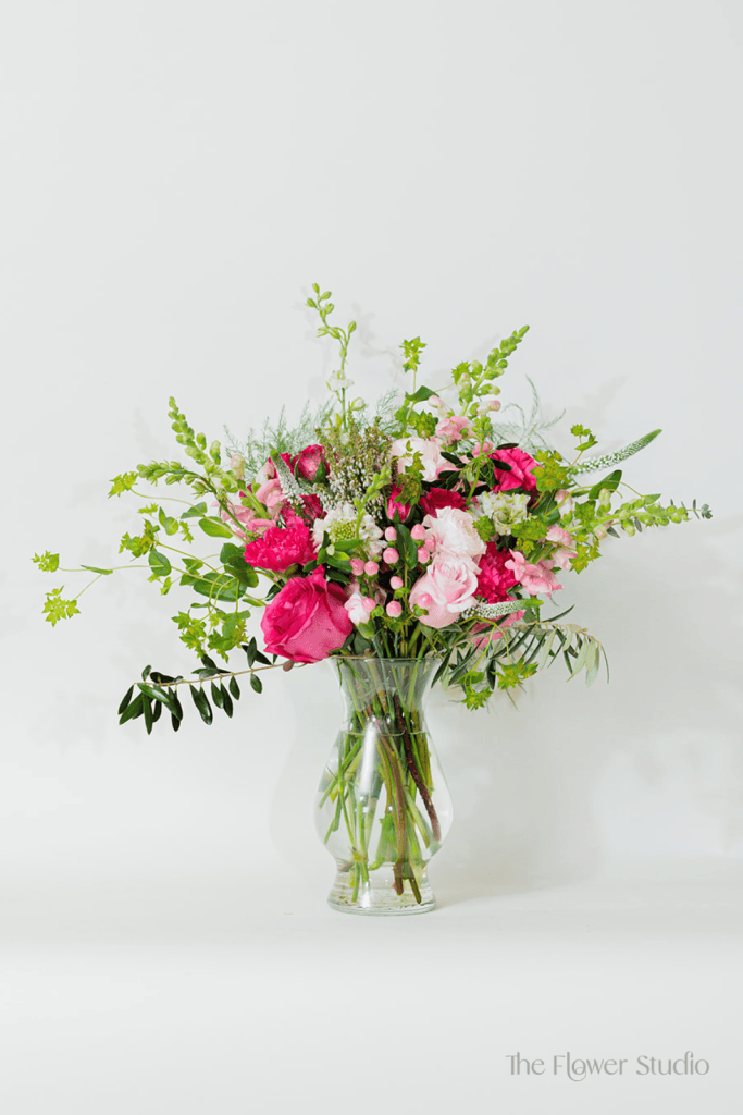 Bold, beautiful, and full of charm, this stunning arrangement features a captivating mix of hot pinks, blush tones, and delicate textures.
