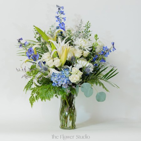 Soft, serene, and full of elegance, this stunning arrangement combines a perfect blend of white, blue, and purple tones for a breathtaking display.