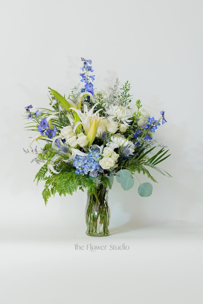 Soft, serene, and full of elegance, this stunning arrangement combines a perfect blend of white, blue, and purple tones for a breathtaking display.