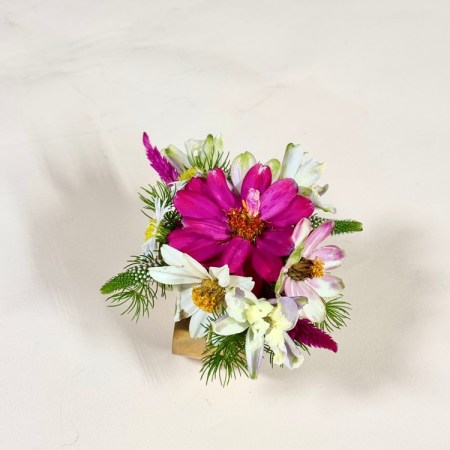 Add a touch of elegance to any occasion with our corsage designed on a stylish cuff.